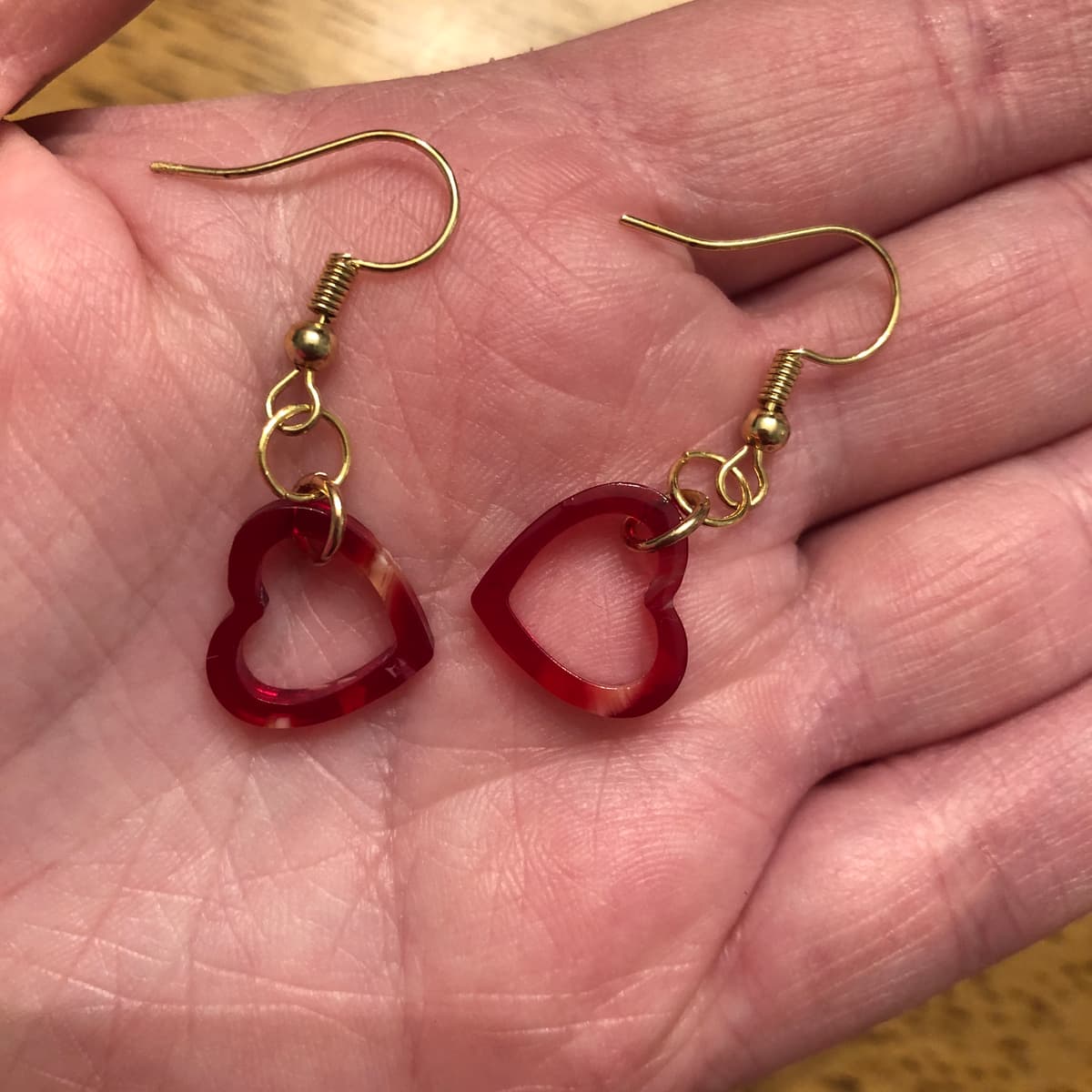 The selected image of Dainty Red Acrylic Heart Dangle Earrings