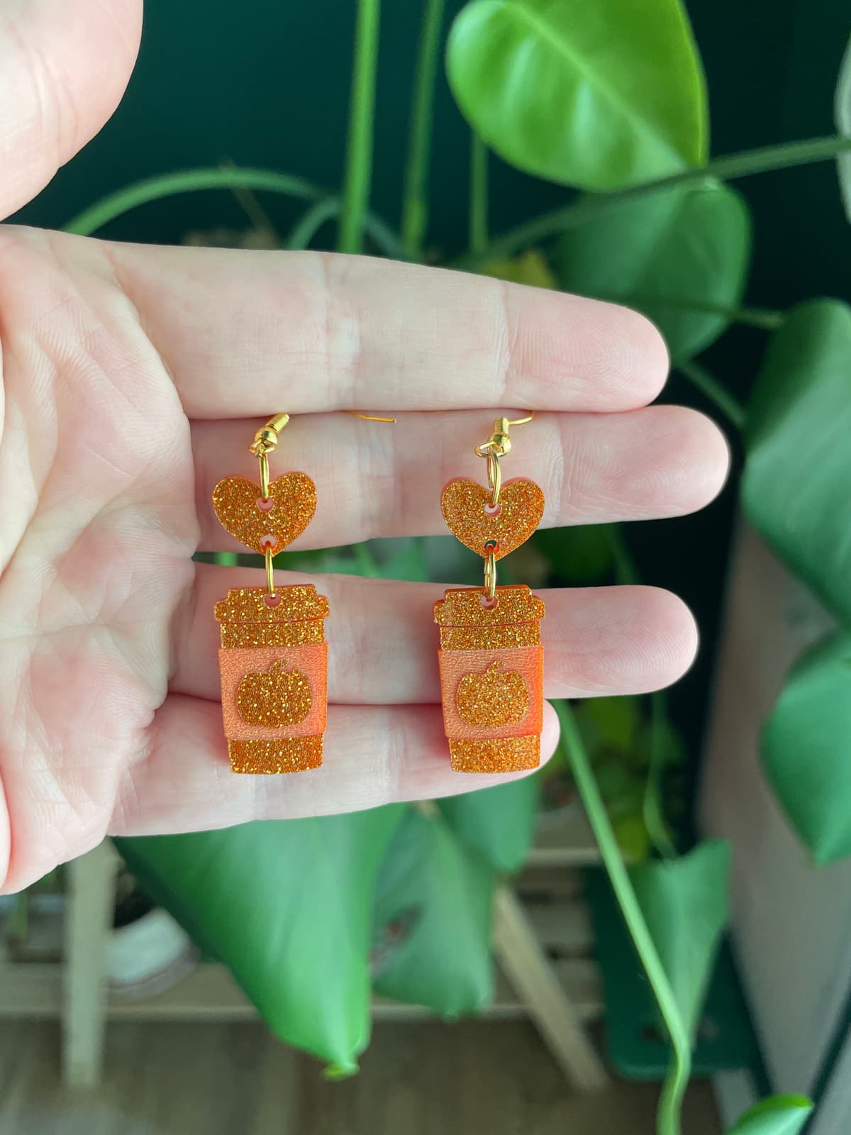 The selected image of Glittery Orange Pumpkin Spice Coffee Cup Acrylic Dangle Earrings